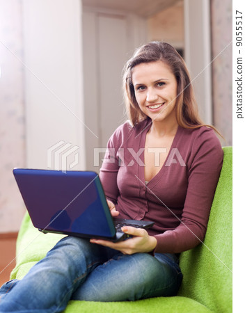 woman using netbook in home woman using netbook in home 9055517