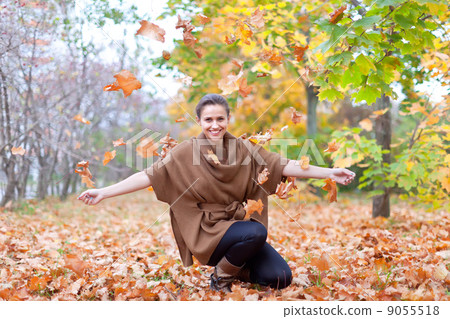 Woman throws autumn leaves Woman throws autumn leaves 9055518