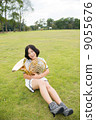 Horn player image (sitting, lawn) 9055676