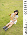 Horn player image (sitting, lawn) 9055678