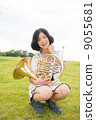 Horn player image (sitting, lawn) 9055681
