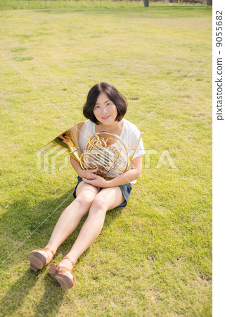 Horn player image (sitting, lawn) Horn player image (sitting, lawn) 9055682