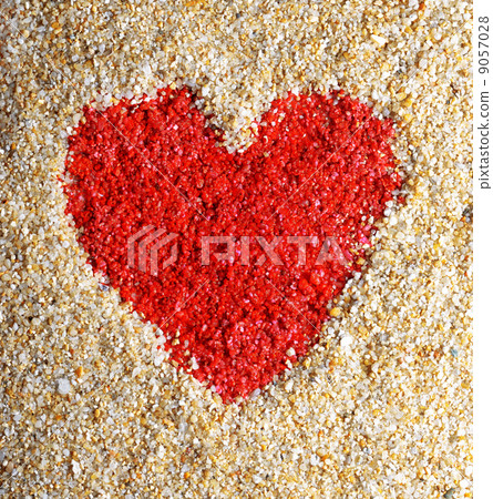 Red heart sign in yellow sand 9057028