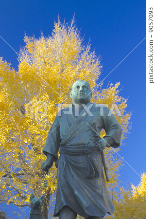 Mr. Saigo standing against autumn sky and ginkgo Mr. Saigo standing against autumn sky and ginkgo 9057093