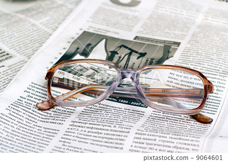 reading glasses lying on a newspaper reading glasses lying on a newspaper 9064601