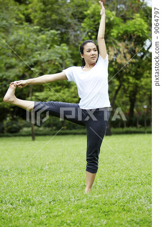 Attractive Healthy Asian Woman doing yoga in the park 9064797