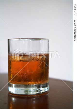 glass of whisky with an ice 9073351