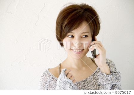 A smartphone and a woman A smartphone and a woman 9075017