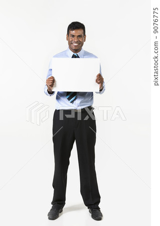 Indian man holding up a banner. Indian man holding up a banner. 9076775