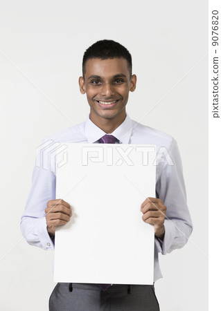 Indian man holding up a banner. Indian man holding up a banner. 9076820