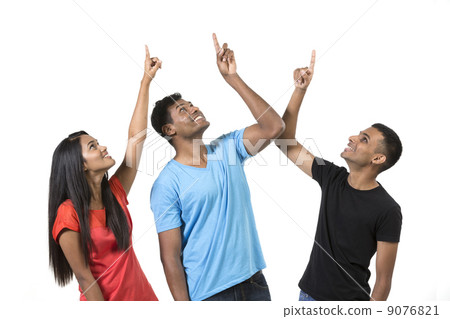 Group of happy Indian friends pointing upwards. Group of happy Indian friends pointing upwards. 9076821