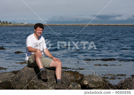 Man at the coastline of Runde Island (Norway) 9080898