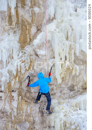 Young man climbing the ice Young man climbing the ice 9086024