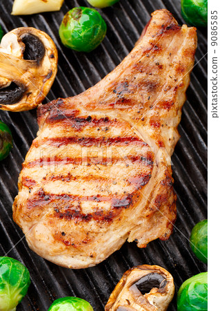 Grilled pork chop with brussels sprouts 9086585