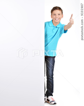 boy looks out from the  white banner with thumbs up gesture 9101987