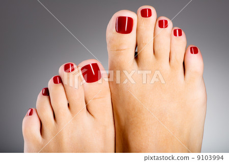 Beautiful female feet with red pedicure Beautiful female feet with red pedicure 9103994