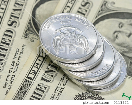 Yuan coins on dollar bill Yuan coins on dollar bill 9115521
