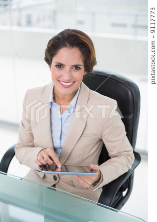 Smiling businesswoman using tablet Smiling businesswoman using tablet 9117773