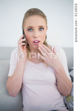 Casual shocked blonde phoning 9118058
