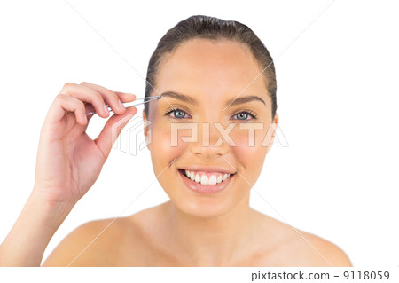 Smiling woman using her tweezers 9118059