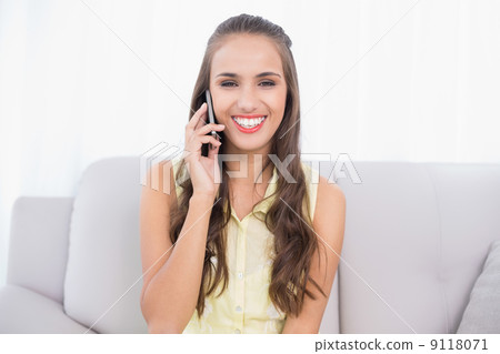 Cheerful pretty brunette using mobile phone Cheerful pretty brunette using mobile phone 9118071