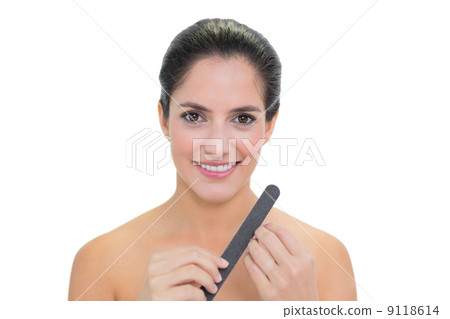 Smiling bare brunette filing nails 9118614