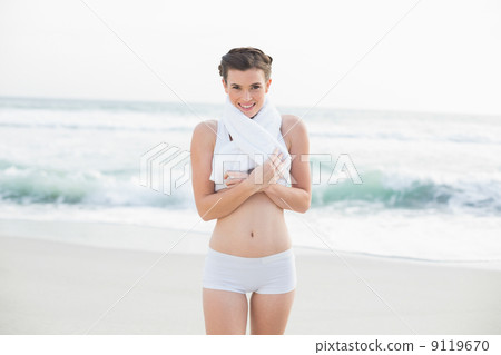 Content slim brown haired model in white sportswear wearing a to Content slim brown haired model in white sportswear wearing a to 9119670
