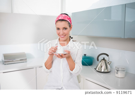 Happy charming woman holding cup of tea Happy charming woman holding cup of tea 9119671