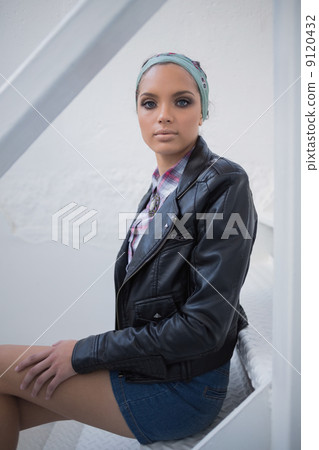 Attractive woman sitting on stairs 9120432