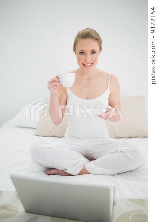 Natural cheerful blonde holding a cup Natural cheerful blonde holding a cup 9122154