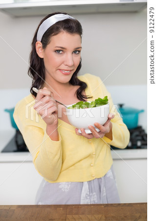 Content gorgeous model holding healthy salad Content gorgeous model holding healthy salad 9122479