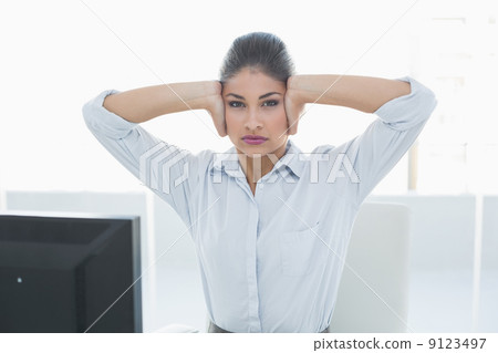Young businesswoman suffering from headache in front of computer Young businesswoman suffering from headache in front of computer 9123497