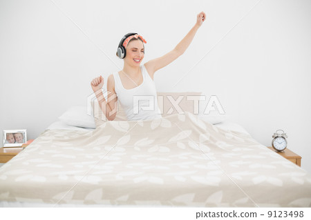 Pretty woman listening to music 9123498
