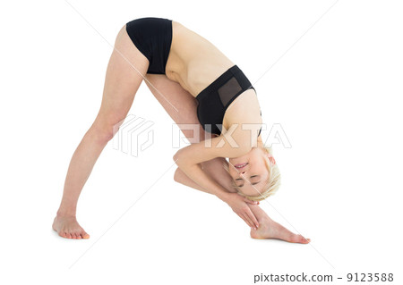 Full length of sporty woman bending down to her leg 9123588