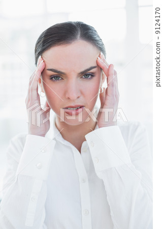 Elegant businesswoman suffering from headache 9124170
