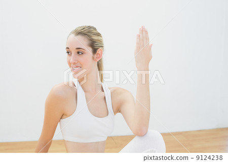 Gorgeous sporty woman doing yoga pose sitting on floor 9124238