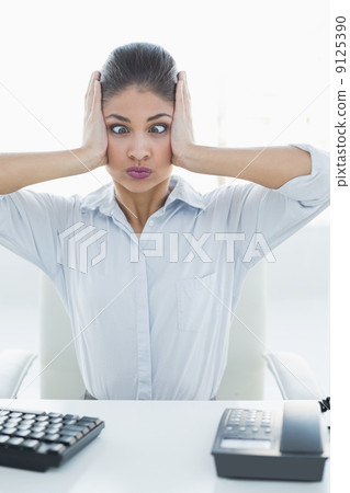 Businesswoman suffering from headache at office Businesswoman suffering from headache at office 9125390