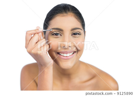 Smiling nude brunette using tweezers 9125890