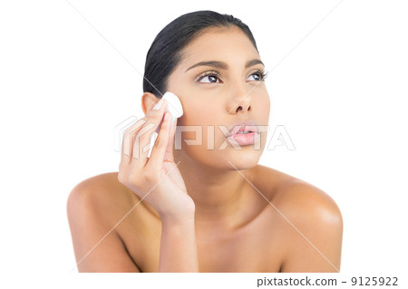 Frowning nude brunette holding cotton ball 9125922