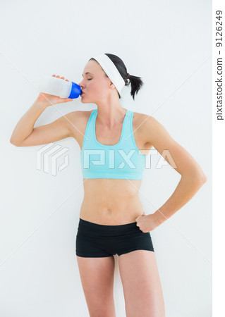Sporty fit young woman drinking water 9126249