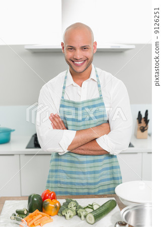 Smiling young man with vegetables in kitchen 9126251