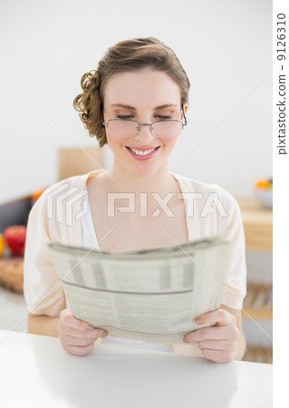 Beautiful young woman wearing glasses for reading newspaper Beautiful young woman wearing glasses for reading newspaper 9126310
