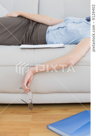 Mid section of slender classy businesswoman lying on couch sleep Mid section of slender classy businesswoman lying on couch sleep 9126402