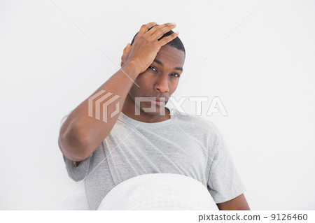 Afro man suffering from headache in bed 9126460