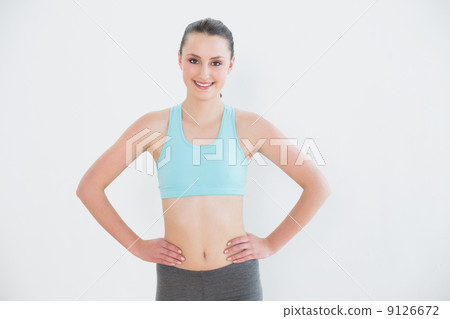 Portrait of a toned woman against wall Portrait of a toned woman against wall 9126672