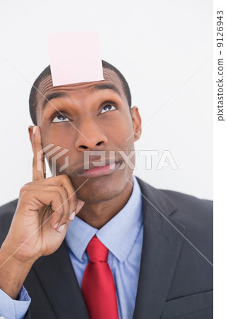 Afro businessman with blank note on forehead Afro businessman with blank note on forehead 9126943