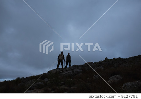 Couple on rocky landscape against the sky at night Couple on rocky landscape against the sky at night 9127791