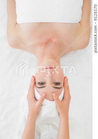 Hands massaging woman's face at beauty spa 9128170