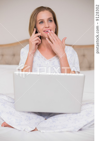 Natural shocked woman using laptop and phoning 9128302
