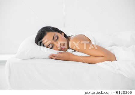 Calm sleeping woman lying on her bed Calm sleeping woman lying on her bed 9128306